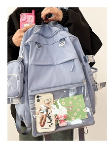 Close-up of light blue nylon backpack with transparent PVC pocket for personalized decoration