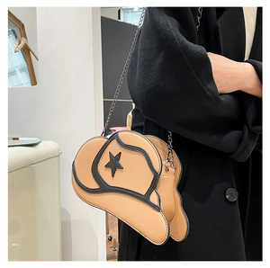 Detail of creative cowboy hat shaped shoulder bag with star pattern and metal chain