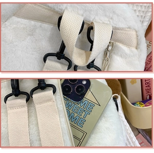 Detail of plush white backpack featuring durable canvas straps and secure metal hooks