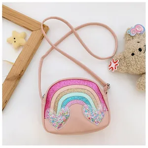 Detail of pink rainbow crossbody bag featuring transparent glitter heart pockets