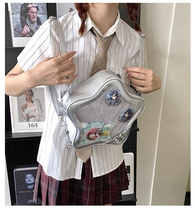 Detailed view of silver star-shaped ita bag with a clear window for anime pin badges