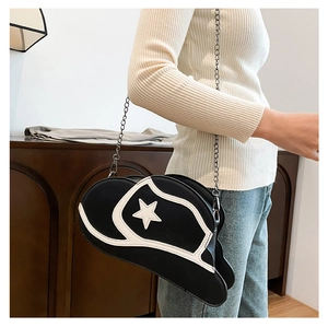 Close-up of cowboy hat shaped crossbody bag with star detail and metal chain strap