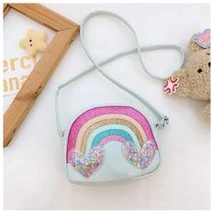Close-up of kids light blue mini crossbody bag with glittery rainbow and sequined hearts