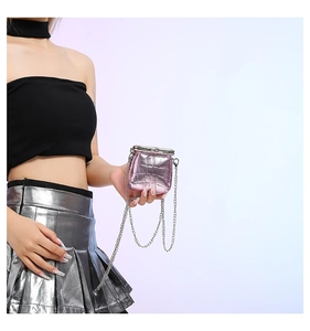 Close-up of mini pink stone pattern chain bag with vintage metal clasp held by hand