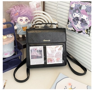 Detail of black PU leather ita bag with large clear display window and top handle