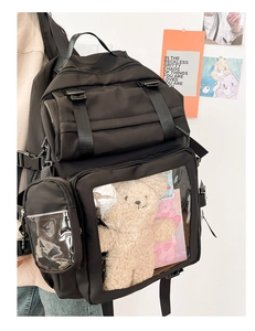 Side view of black Japanese style backpack with transparent PVC window for doll display