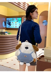 Detailed view of plush dog bag with soft fleece texture and cute blue apron design