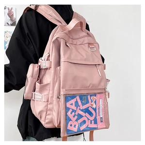 Side view of a pink nylon school backpack with transparent PVC pocket and side buckles