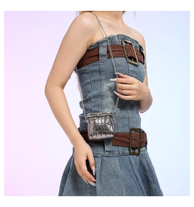 Detail of silver crocodile-embossed mini crossbody bag with vintage metal clasp and chain