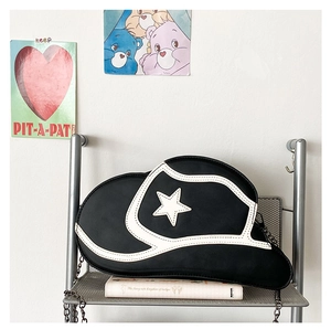Detail of creative cowboy hat shaped crossbody bag with white star applique and chain