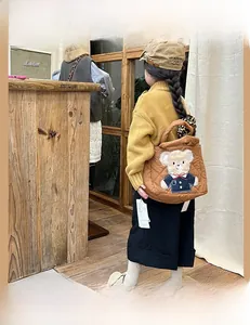 Brown quilted crossbody bag for kids featuring a cute cartoon bear patch detail