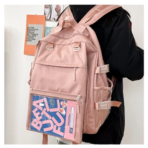 Detail view of pink student backpack with multi-layer zippers and transparent pocket