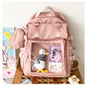 Detailed view of pink Japanese ita-bag with large transparent window and plush duck accessory