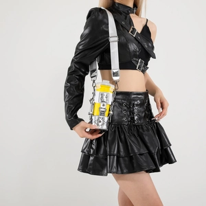Futuristic yellow cylinder crossbody bag with silver rivet metal frame and strap