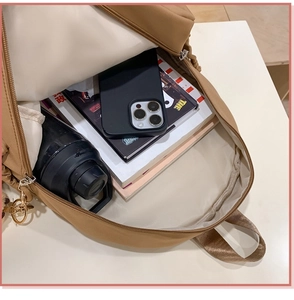 Interior view showing the large capacity and storage compartments of the khaki backpack