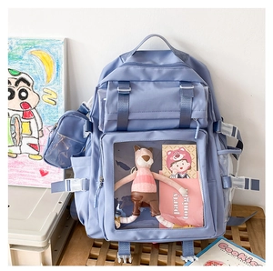 Detail of purple nylon backpack with a transparent PVC pocket showing plush accessories