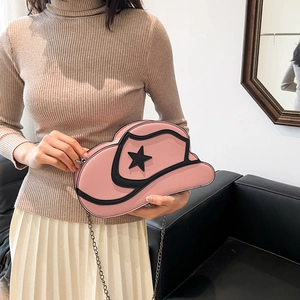 Pink cowboy hat shaped crossbody bag with black star detail and chain strap