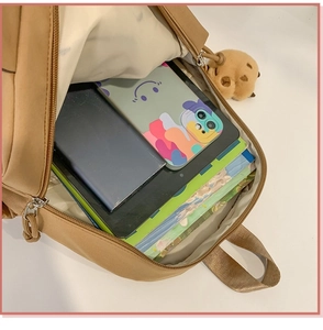 Open view of cute brown student backpack showing spacious interior for books and gadgets