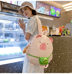 Pink cartoon animal backpack detail with a 3D turtle charm and plush decoration