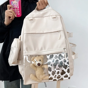 Minimalist beige school backpack with clear PVC pocket and cute plush bear charm