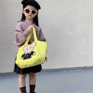 Bright yellow quilted crossbody bag for kids featuring a cute cartoon bear embroidery