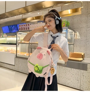 Pink Capybara backpack featuring 3D nose detail and a green turtle pocket design