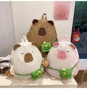 Detailed view of cute capybara backpacks in brown, white and pink with turtle charms