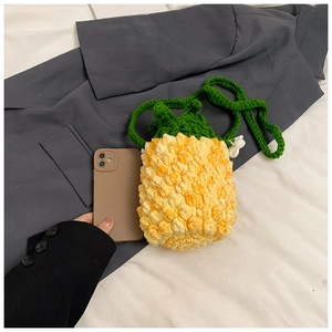 Detailed view of hand-crocheted pineapple crossbody bag with green leaf texture