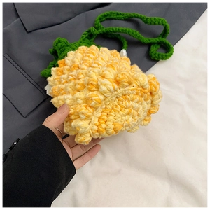 Detailed close-up of handmade crochet pineapple bucket bag with green leaf and texture