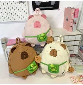 Detailed view of three cute capybara plush backpacks in pink, brown and cream colors