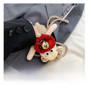 Detail of hand-crocheted monkey bag showing interior capacity with a single lipstick