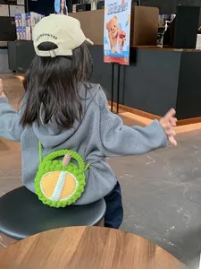 Handmade crochet durian shoulder bag for kids featuring a unique 3D spiked green design