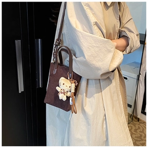 Brown matte mini tote crossbody bag styled with a leopard-print kitten plush keychain