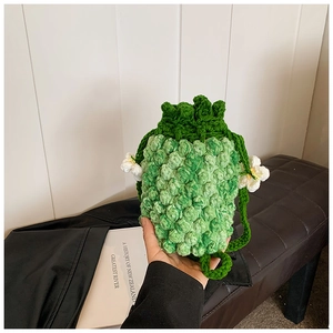 Detailed close-up of handmade crochet pineapple bucket bag with green gradient knit texture