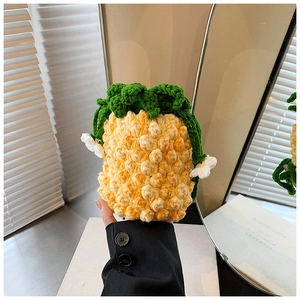 Close-up of handmade crochet pineapple bucket bag featuring detailed yellow knit texture