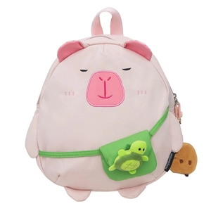 Cute pink capybara plush backpack for students with green turtle doll charm on white background