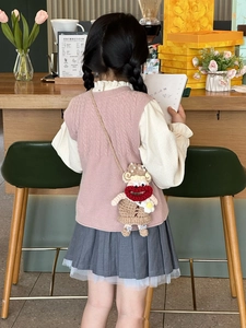 Detail of a handmade crochet cartoon crossbody bag worn with a stylish girls outfit