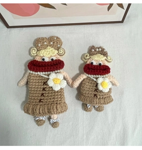 Detail of handmade crochet doll bags with unique sausage lips and cute daisy accents