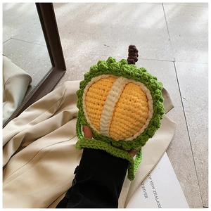 Macro detail of hand-crocheted durian-shaped bag showing cotton texture and creative design