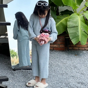Kids light blue knit sweater set and wide-leg pants with pink crochet doll bag accessory