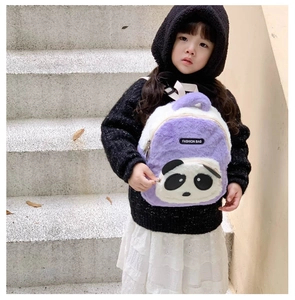 Toddler wearing a plush purple and white panda backpack with adjustable straps outdoors