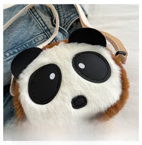Detail of cute panda plush bag featuring soft faux fur texture and woven shoulder strap