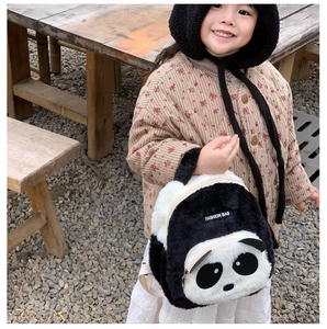 Close-up of plush panda backpack with soft faux fur texture and fashion label