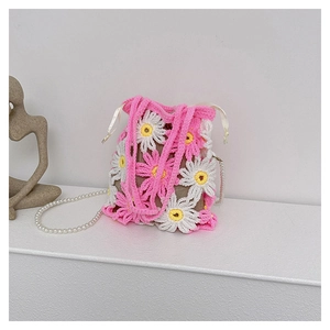 Detail of handmade crochet bucket bag with daisy pattern and pearl crossbody chain strap