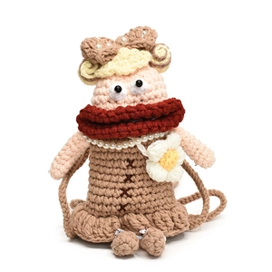 Handmade crochet doll shoulder bag featuring a cute cartoon character and pearl details