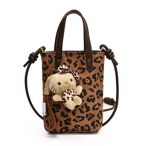 Leopard print crossbody bag with faux suede texture and cute plush cat charm decoration