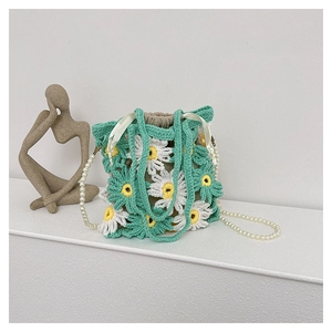 Detail of crochet daisy handbag with pearl strap and silk drawstring closure