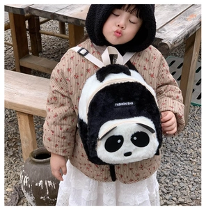Detail of plush panda backpack showing soft faux fur texture and adjustable white straps