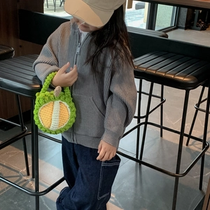 Handmade crochet durian shoulder bag for kids featuring a green shell and yellow fruit core