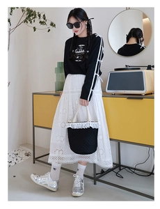Modische schwarze Stepptasche mit Spitzenbesatz und Schleifendetails am Mädchenoutfit